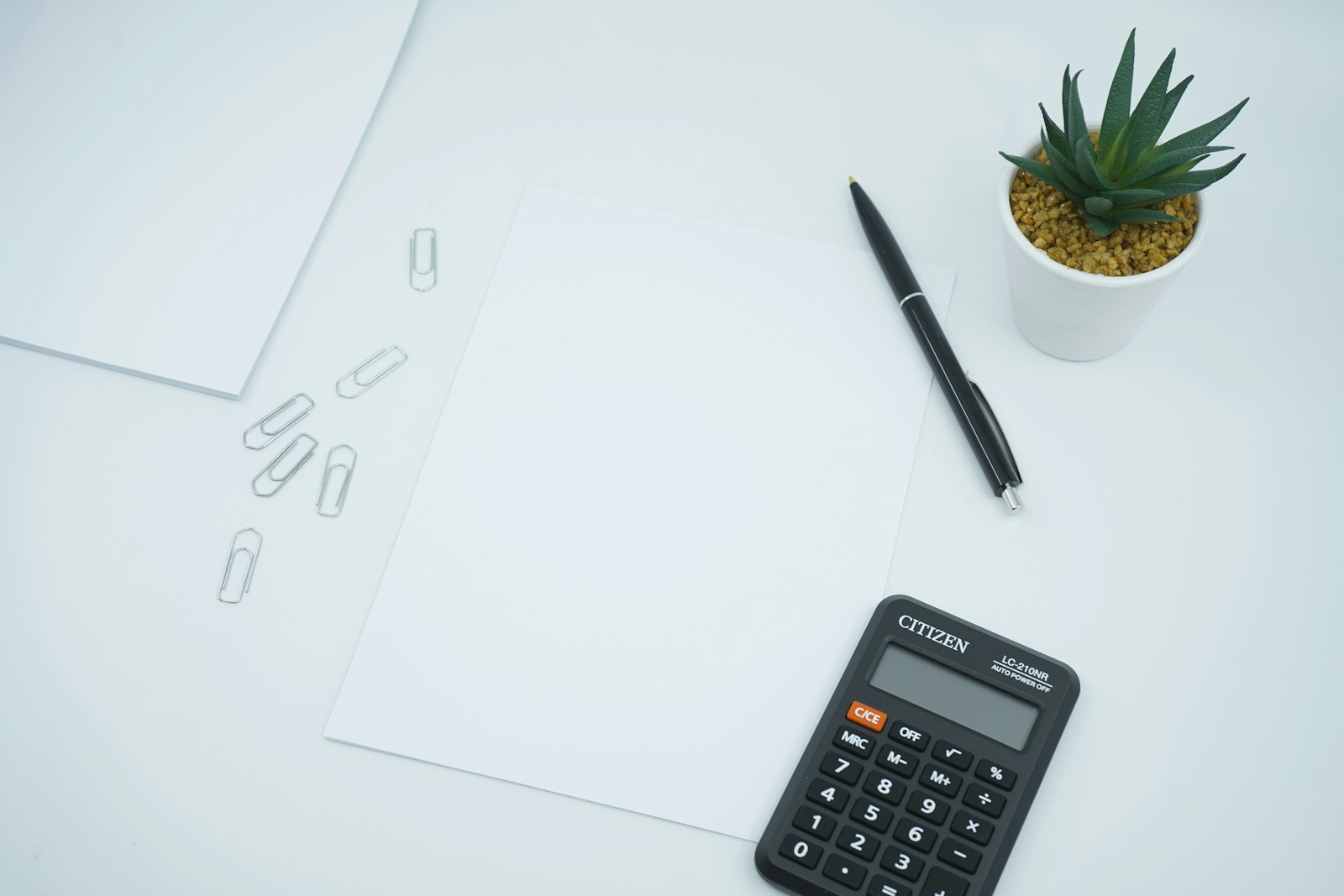 Paper, pen and calculator; illustrative stock photograph